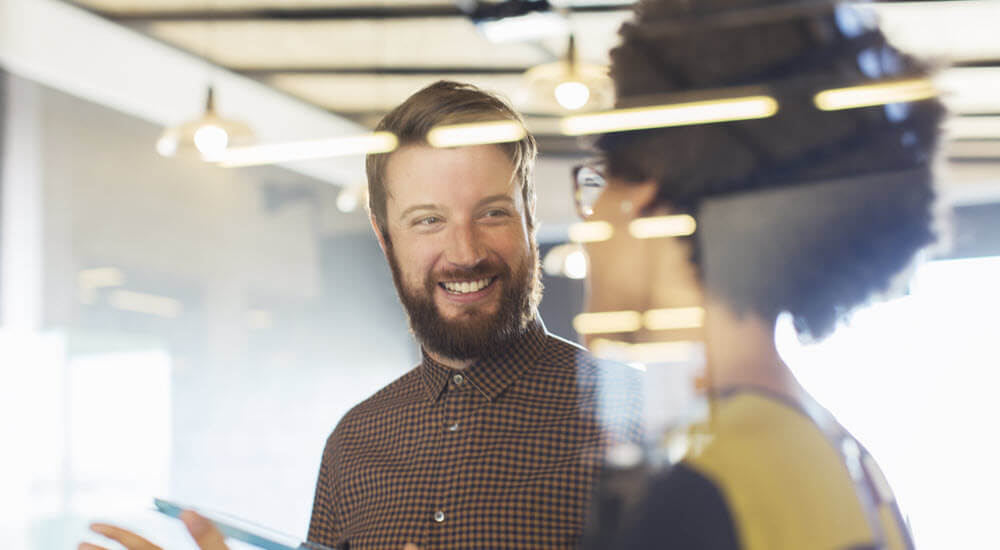Two colleagues having a conversation in office
